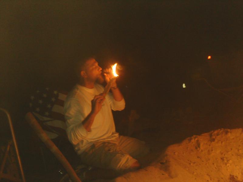 18 COWBOY lighting a cigar with some firewood.jpg